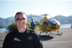 A PHI flight paramedic poses in front of one of our air medical helicopters. 